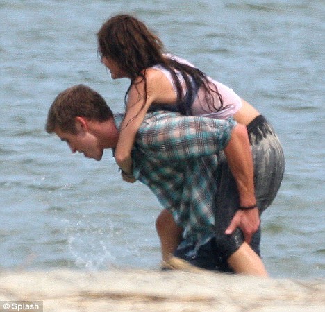 Miley and Liam frolic in the water