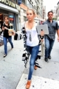 Holding A Coffee and Ipad Leaving Starbucks In New York CA (1)