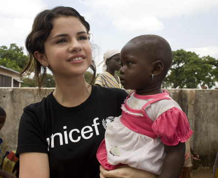 Unicef Ambassador Selena Gomez stands with children in Tamale, Ghana on September 5, 2009 - selena gomez 2011