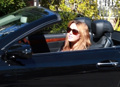 normal_mileylipgloss_(2) - 0-0 Miley Applying Lip Gloss In Her Convertible