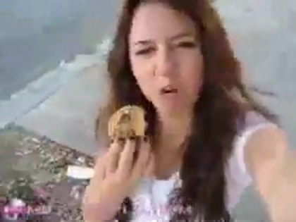   (248) - Miley Cyrus filming herself eating a big cookie - Captures