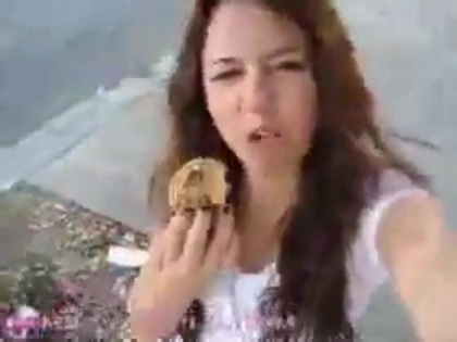   (249) - Miley Cyrus filming herself eating a big cookie - Captures