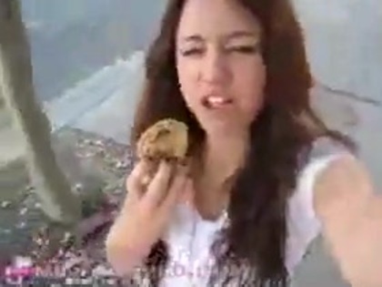   (262) - Miley Cyrus filming herself eating a big cookie - Captures