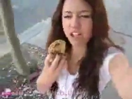   (263) - Miley Cyrus filming herself eating a big cookie - Captures
