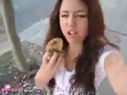   (264) - Miley Cyrus filming herself eating a big cookie - Captures