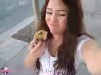   (306) - Miley Cyrus filming herself eating a big cookie - Captures