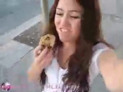   (308) - Miley Cyrus filming herself eating a big cookie - Captures