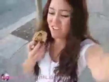   (309) - Miley Cyrus filming herself eating a big cookie - Captures