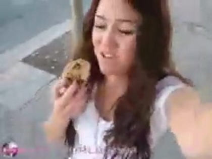   (310) - Miley Cyrus filming herself eating a big cookie - Captures