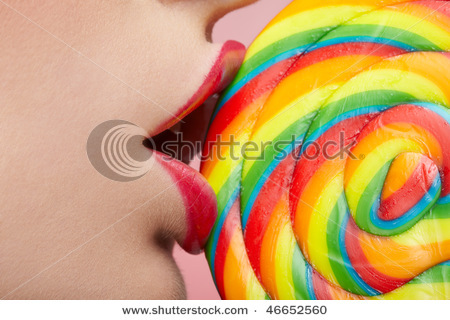 stock-photo-close-up-of-beautiful-girl-s-lower-part-of-face-lips-are-sliding-over-big-lollipop-46652 - Buze