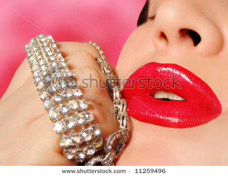 stock-photo-diamonds-are-a-girl-s-best-friend-woman-with-red-glossy-lipstick-holding-a-diamond-brace - Buze