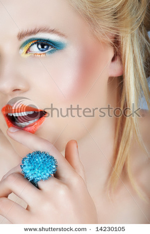 stock-photo-happy-blond-beauty-with-golden-and-blue-eyedhadow-touching-her-orange-lips-14230105