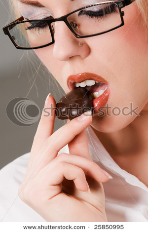 stock-photo-pretty-woman-holding-chocolate-heart-shaped-candy-25850995