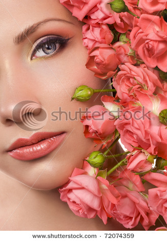 stock-photo-woman-with-beautiful-makeup-and-bouquet-of-coral-roses-72074359