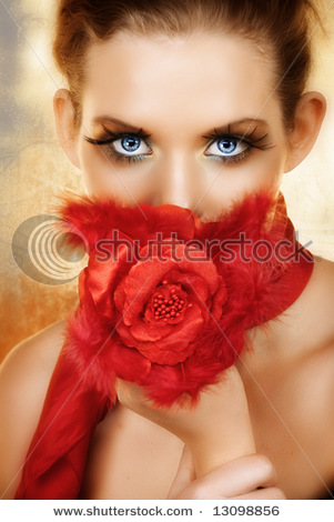 stock-photo-blond-beautiful-woman-with-red-silk-flowers-and-feathers-hiding-her-face-blue-eyes-with-