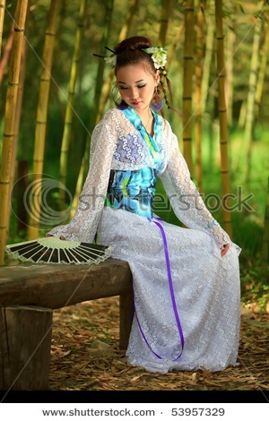 stock-photo-the-japanese-with-a-fan-sitting-on-a-bench-in-bamboo-wood-53957329