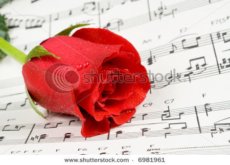 stock-photo-red-rose-rests-on-piano-sheet-music-6981961 - Ceva special