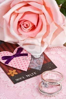 5270834-close-up-of-soul-mate-note-and-rings-witih-pink-rose-in-background