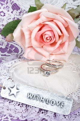 5320144-with-love-tag-in-front-of-pink-rose-and-rings-on-satin-and-lace-heart-pillow