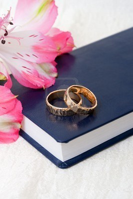 6616522-wedding-rings-placed-on-a-bible-with-flowers