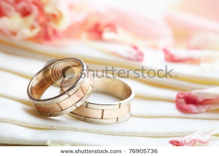 stock-photo-golden-rings-and-rose-petals-76905736