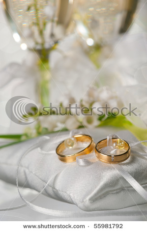 stock-photo-wedding-rings-and-glasses-with-a-champagne-55981792