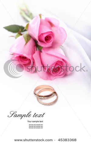 stock-photo-wedding-rings-and-pink-roses-45383368