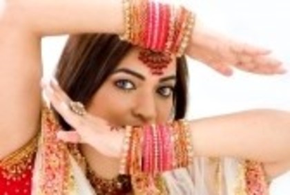photo_3746878_beautiful-face-of-a-bengali-bride-with-her-arms-across-her-head-covered-with-colorful-