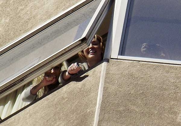 003 - Miley Cyrus waving to fans from their hotel window in Chile