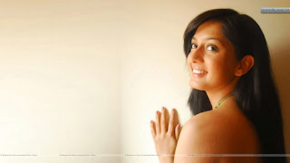 Parvati-Vaze-Standing-With-Wall-Side-Face-Pose-Green-Top