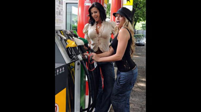 Fill 'er up! The Divas joke around at the gas pumps. - Kelly Kelly and Candice Michelle in Spain and Italy