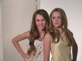 miley cyrus and emily osment looking like they're forcing themselves to be next to each other