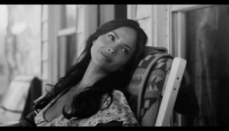 ⸺Next to him, Francesca stretched her bare legs out on Zade’s lap, a vaporous white dress; rising slightly above her thighs. She rested her head on her arm, a glass of wine resting on her chest, looking up at him with a knowing smile.
