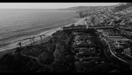 ⸺　2018¸ Laguna Beach　⸺ The sun was setting over the Pacific, bathing Laguna Beach in; a warm, golden light, like a promise no one would ever keep. The air smelled of salt and forgotten promises, and the waves crashed against the rocks in a familiar rhythm, the only thing that seemed
