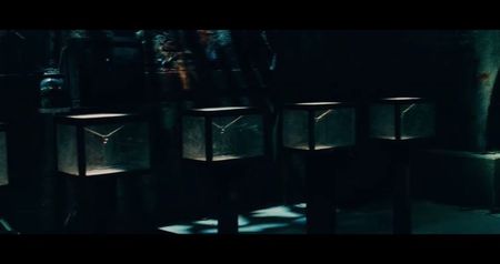 deprivation.” Six metal chairs slide out from the wall. On the table in the center: six needles,; filled with clear liquid. Above them, a digital display: DOSAGE REQUIRED: 7 MG — EXACTLY. If they inject less, their hearts will stop. If they inject more, their veins will burn from the inside out.
