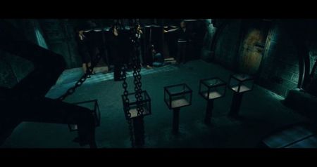 Holden’s press badge. Amir’s courtroom pin. Sylvia’s stolen manuscript. Janice’s wedding ring.; Evan’s tape recorder. Corvinus’ paintbrush, stained with human ash. The group realizes: one of them must destroy their symbol of greed to stop the countdown. 10:00. No one moves.
