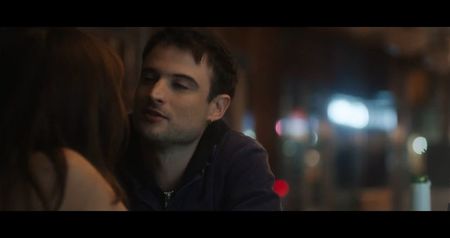 Evan, shaking, backs away from the group. “I’m not... I can’t... it’s not under mine!” Right as; he says that, Janice yells: “check again!” followed by his reaction, “I said it’s not under mine!” He grabs one of the broken mirror shards defensively as the others move closer.
