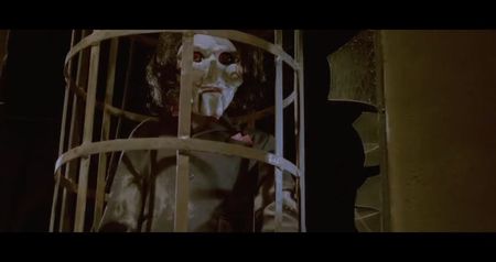 restraints extending outward like spokes of a wheel. Each restraint ends with a wrist shackle; and a coiled wire running to a panel of monitors. Above the table, screens flicker on, displaying each of their faces in real-time—alongside fluctuating heart rate and brainwave readings.
