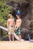 Dylan and Cole Sprouse with a parrot at Hawaii