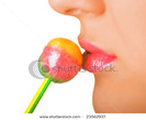 stock-photo-a-women-with-the-brightly-painted-lips-eating-a-lollipop-candy-shallow-dof-23562937
