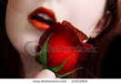 stock-photo-bright-red-lips-and-rose-on-pale-face-23522854