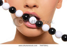 stock-photo-woman-s-lips-with-black-and-white-beads-isolated-on-white-74975941