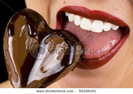 stock-photo-a-beautiful-young-woman-biting-into-a-chocolate-heart-56246101
