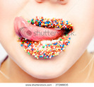 stock-photo-close-up-of-woman-tongue-and-lips-with-multicolored-pearls-27288835