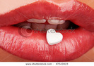 stock-photo-heart-shaped-pill-on-red-woman-s-lips-47542423