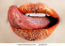 stock-photo-macro-of-bright-orange-make-up-on-lips-with-tongue-licking-off-chocolate-powder-16456219