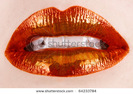 stock-photo-macro-of-woman-s-lips-with-orange-and-metallic-lipstick-64233784