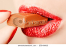 stock-photo-red-lips-eating-chocolate-close-up-shot-37548862