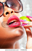 stock-photo-sensual-tanned-woman-eating-a-slice-of-lime-57685342