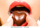 stock-photo-woman-eating-heart-shaped-chocolate-candy-43763209